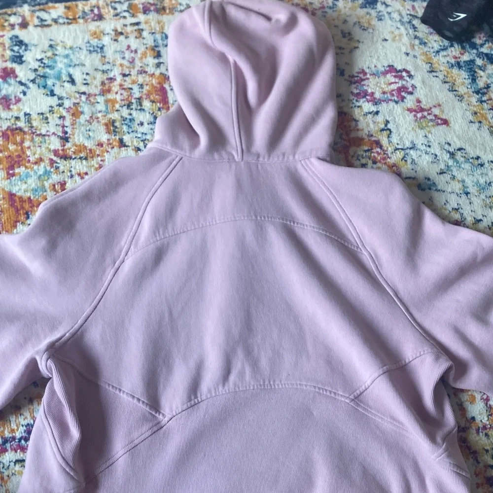 Women's jacket tag inside a pink hoodie